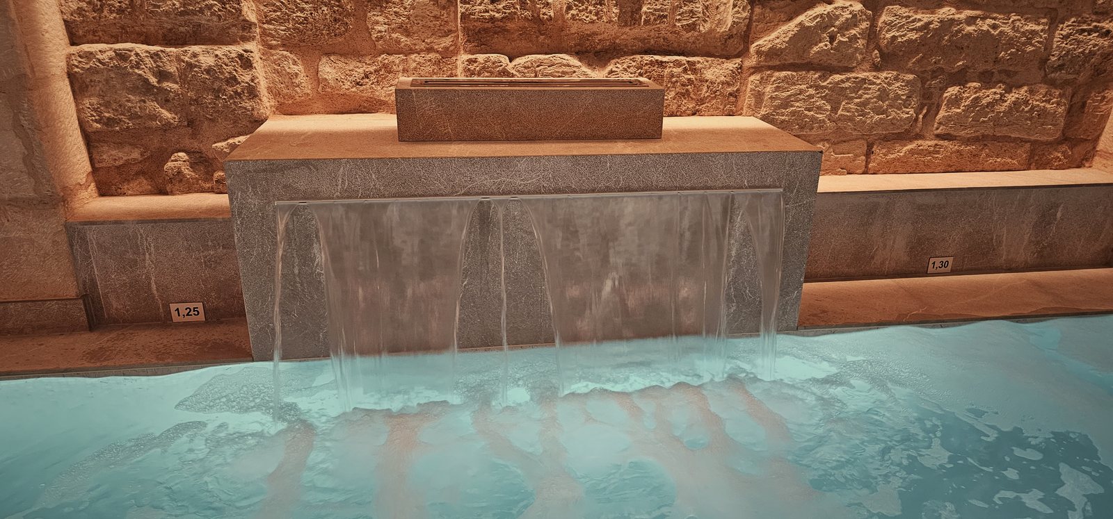 The waterfall in the cistern pool beneath Glòria de Sant Jaume