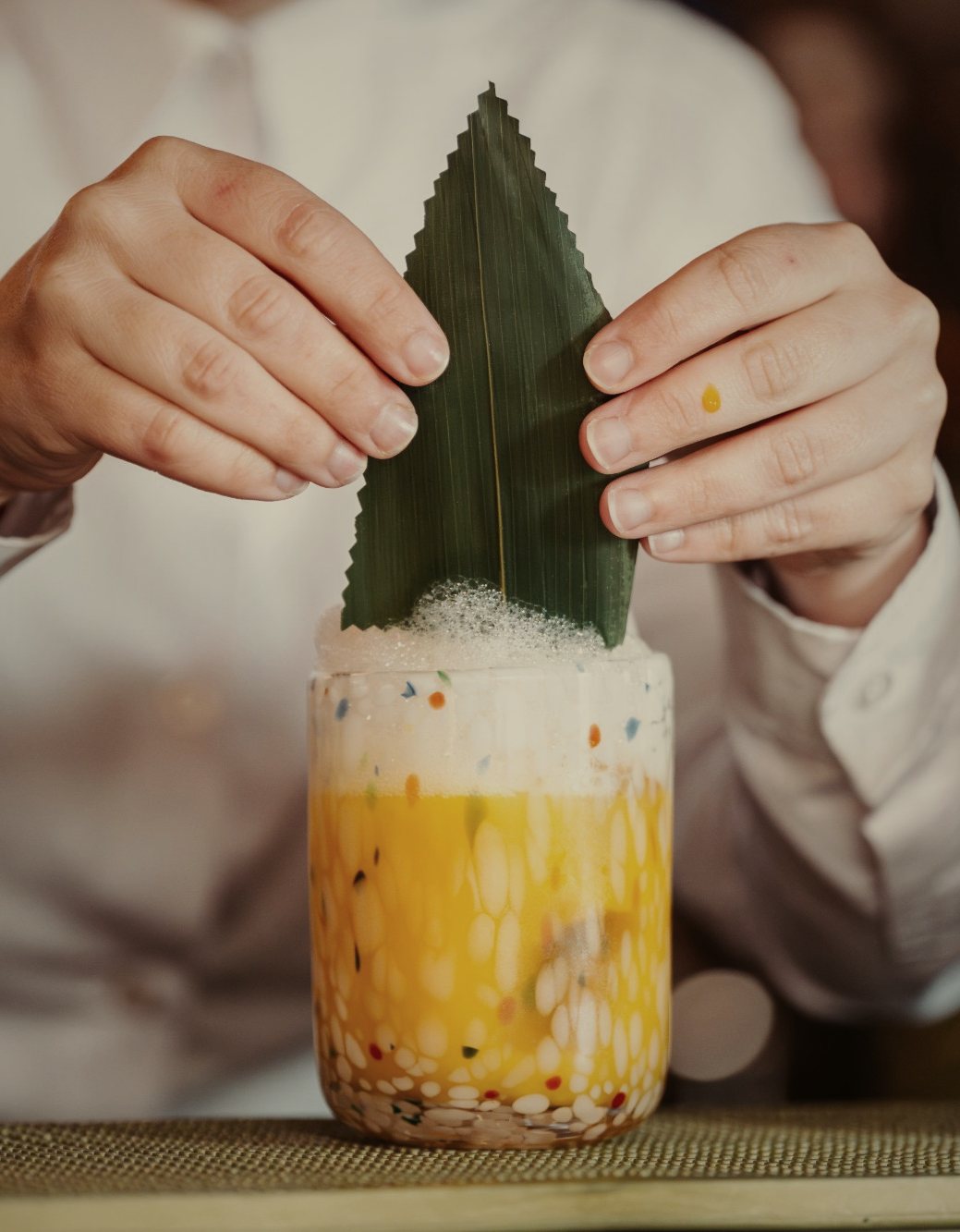 A cocktail being finished at the bar of El Patio de Glòria