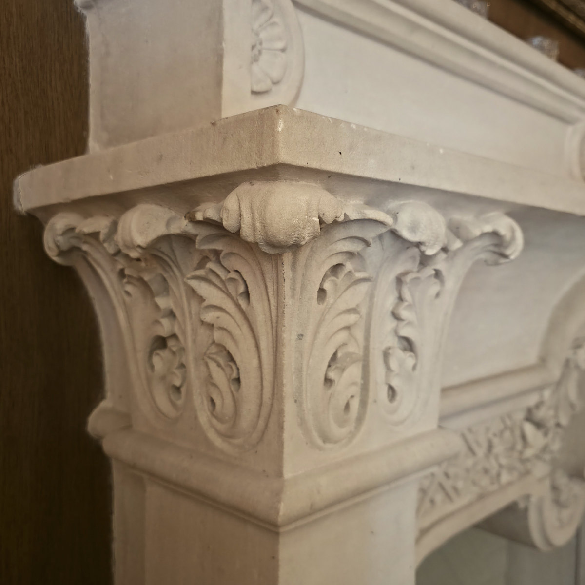 A carved Santanyí stone capital on a fireplace at Glòria de Sant Jaume